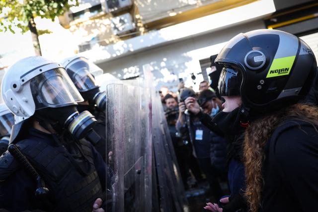A protester reacts while facing anti-riot police officers during an anti-government demonstration in central Tirana on October 16, 2026, as protests continued for a fourth consecutive day over university conditions and demands for the resignation of Albanian Prime Minister Edi Rama. For more than four months, anti-government protests in Albanian have routinely drawn crowds in their thousands. They were originally sparked by a luxury hotel project linked to US President Donald Trump's family, which scientists said in July 2026 had already caused irreparable damage to a once pristine stretch of Albania's coast. (Photo by Adnan Beci / AFP)