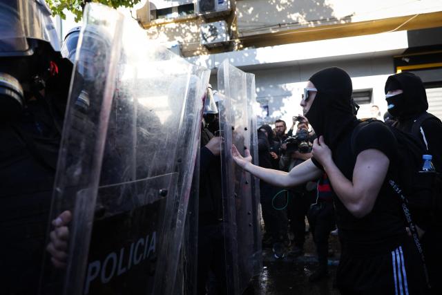 A protester reacts while facing anti-riot police officers during an anti-government demonstration in central Tirana on October 16, 2026, as protests continued for a fourth consecutive day over university conditions and demands for the resignation of Albanian Prime Minister Edi Rama. For more than four months, anti-government protests in Albanian have routinely drawn crowds in their thousands. They were originally sparked by a luxury hotel project linked to US President Donald Trump's family, which scientists said in July 2026 had already caused irreparable damage to a once pristine stretch of Albania's coast. (Photo by Adnan Beci / AFP)