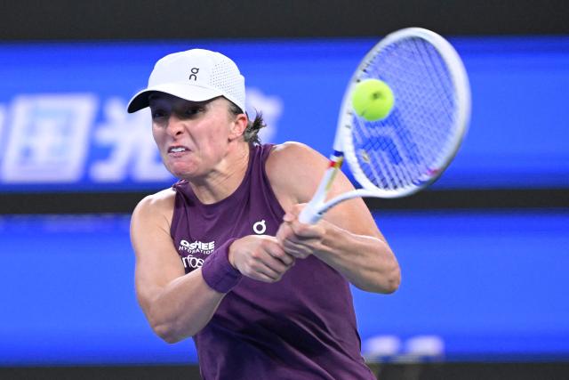 Poland’s Iga Swiatek hits a return to USA's Ann Li during their women’s singles quarter-final match at the Wuhan Open tennis tournament in Wuhan, China's Hubei province on October 16, 2026. (Photo by WANG Zhao / AFP)