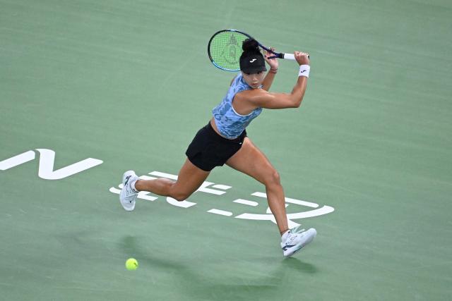 USA's Ann Li hits a return to Poland’s Iga Swiatek during their women’s singles quarter-final match at the Wuhan Open tennis tournament in Wuhan, China's Hubei province on October 16, 2026. (Photo by WANG Zhao / AFP)