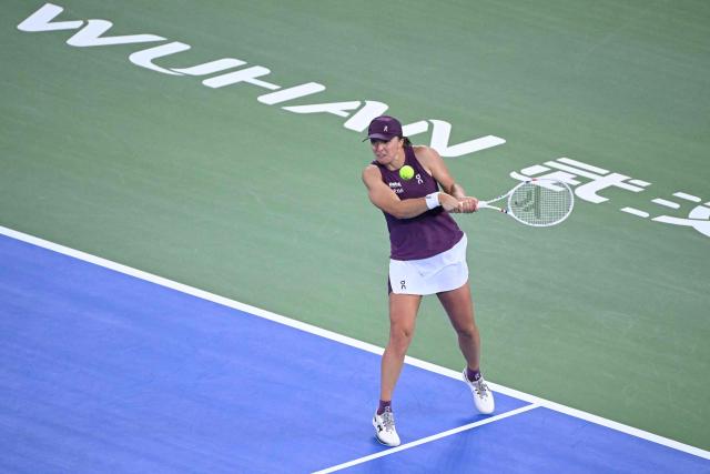 Poland’s Iga Swiatek hits a return to USA's Ann Li during their women’s singles quarter-final match at the Wuhan Open tennis tournament in Wuhan, China's Hubei province on October 16, 2026. (Photo by WANG Zhao / AFP)