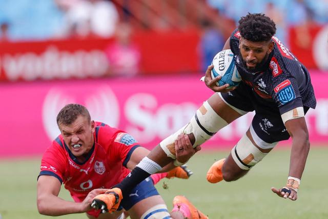 (FILES) Sharks' Hyron Andrews (R) is tackled by Bulls' Walt Steenkamp (L) during the United Rugby Championship (URC) match between South African teams The Bulls from Pretoria and The Sharks from Durban at Loftus Versfeld Stadium in Pretoria on October 30, 2022. South African rugby player Hyron Andrews of Johannesburg-based side the Lions was found dead at a hotel in France on October 16, 2026, on the eve of his team's Champions Cup match against La Rochelle, local authorities told AFP. (Photo by Phill Magakoe / AFP)