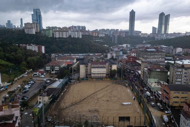 This aerial photograph shows a football pitch covered with mud and debris, two days after flooding caused by what officials said was the heaviest rainfall in the city since records began more than 80 years ago, in the Ayazaga district of Istanbul on October 16, 2026. (Photo by Yasin AKGUL / AFP)