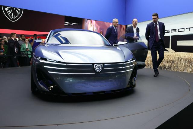 President of French far-right party Rassemblement National (RN) Jordan Bardella looks at a Peugeot RCZ Vision Concept electric car as he visits the Peugeot stand during the 91st edition of the international Paris Motor Show at the Porte de Versailles in Paris on October 16, 2026. (Photo by Thomas SAMSON / AFP)