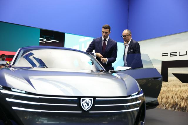 President of French far-right party Rassemblement National (RN) Jordan Bardella looks at a Peugeot RCZ Vision Concept electric car as he visits the Peugeot stand during the 91st edition of the international Paris Motor Show at the Porte de Versailles in Paris on October 16, 2026. (Photo by Thomas SAMSON / AFP)