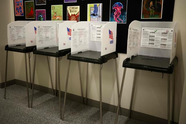 Voting booths are seen in the town hall in Bangor, Maine, during early midterm voting on October 16, 2026. Americans voting in the November 3 midterm elections will decide who controls Congress for the final two years of Donald Trump's presidency, along with dozens of governorships and thousands of state offices. (Photo by CHARLY TRIBALLEAU / AFP)