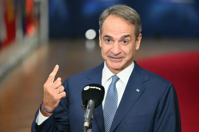 Greece's Prime Minister Kyriakos Mitsotakis makes a doorstep statement at the end of a European Union summit at the EU headquarters in Brussels on October 16, 2026. EU leaders head on October 15, 2026 for their biggest clash yet over the bloc's next long-term budget, as they race to lock in a deal before next year's French presidential election. (Photo by NICOLAS TUCAT / AFP)