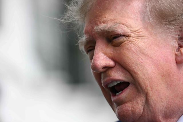 US President Donald Trump speaks to members of the press before boarding Marine One on the South Lawn of the White House in Washington, DC, on October 16, 2026. President Trump is travelling to Georgia and Kentucky for midterm campaign events. (Photo by Jim WATSON / AFP)