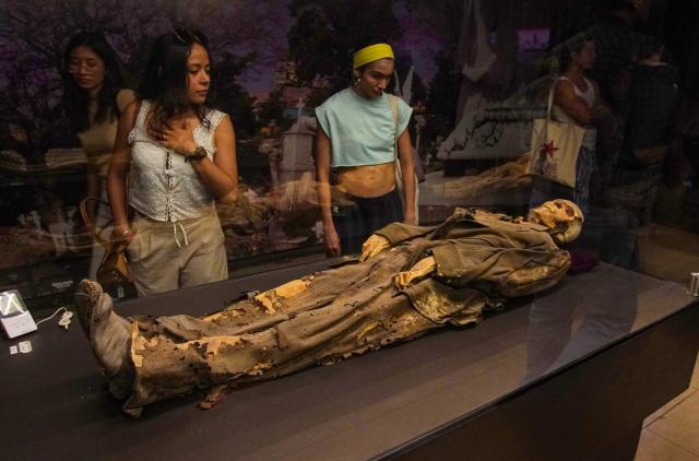Tourists visit the Mummy Museum in the colonial city of Guanajuato, Guanajuato state, Mexico, on October 15, 2026. The museum displays naturally mummified human remains recovered from the city's Santa Paula cemetery. (Photo by Mario ARMAS / AFP)