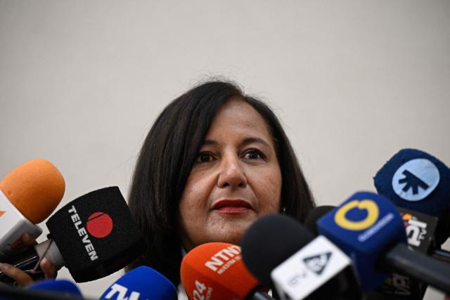 Opposition delegation leader Dinorah Figuera speaks to the media after a meeting with representatives of the health sector to present proposals and demands to the opposition delegation participating in the dialogue process, at the Marriott Hotel in Caracas, Venezuela, on October 16, 2026. (Photo by Federico PARRA / AFP)