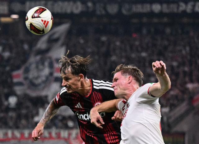 Frankfurt's German defender #04 Robin Koch (L) and FC Cologne's German forward #30 Marius Buelter vie for the ball during the German first division Bundesliga football match between Eintracht Frankfurt and FC Cologne in Frankfurt am Main, western Germany, on October 16, 2026. (Photo by Kirill KUDRYAVTSEV / AFP) / DFL REGULATIONS PROHIBIT ANY USE OF PHOTOGRAPHS AS IMAGE SEQUENCES AND/OR QUASI-VIDEO   ALTERNATIVE CROP