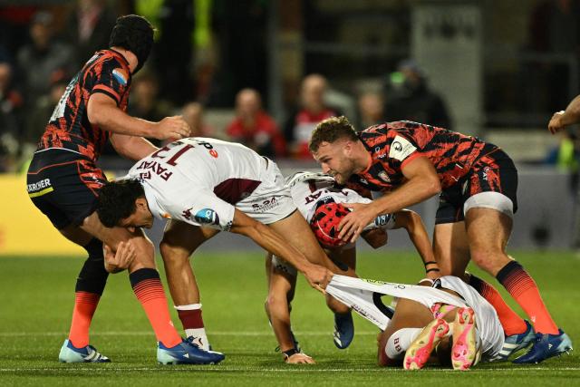 Bordeaux-Begles' French centre Nicolas Depoortere (2L) grabs a handful of a teammates shorts with the ball nowhere to be seen, during the European Champions Cup pool 3 rugby union match between Gloucester and Bordeaux-Begles at the Kingsholm Stadium in Gloucester, western England on October 16, 2026. (Photo by Oli SCARFF / AFP)