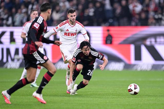 Frankfurt's Japanese defender #26 Keita Kosugi (R) and FC Cologne's German midfielder #05 Tom Krauss vie for the ball during the German first division Bundesliga football match between Eintracht Frankfurt and FC Cologne in Frankfurt am Main, western Germany, on October 16, 2026. (Photo by Kirill KUDRYAVTSEV / AFP) / DFL REGULATIONS PROHIBIT ANY USE OF PHOTOGRAPHS AS IMAGE SEQUENCES AND/OR QUASI-VIDEO