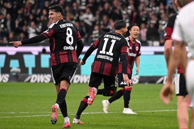 Frankfurt's German forward #11 Younes Ebnoutalib (2nd L) celebrates scoring the opening goal with his teammates including Frankfurt's Algerian midfielder #08 Fares Chaibi (L) during the German first division Bundesliga football match between Eintracht Frankfurt and FC Cologne in Frankfurt am Main, western Germany, on October 16, 2026. (Photo by Kirill KUDRYAVTSEV / AFP) / DFL REGULATIONS PROHIBIT ANY USE OF PHOTOGRAPHS AS IMAGE SEQUENCES AND/OR QUASI-VIDEO   ALTERNATIVE CROP
