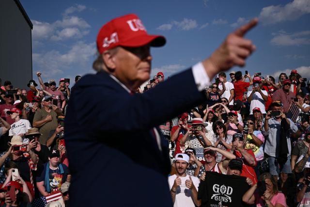 Supporters cheer as US President Donald Trump arrives to speak at a midterm campaign rally at Dalton Municipal Airport in Dalton, Georgia, on October 16, 2026. Trump is campaigning for US Representative Mike Collins for US Senate and Rick Jackson for governor. (Photo by Brendan SMIALOWSKI / AFP)