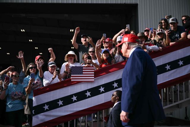 Supporters cheer as US President Donald Trump arrives to speak at a midterm campaign rally at Dalton Municipal Airport in Dalton, Georgia, on October 16, 2026. Trump is campaigning for US Representative Mike Collins for US Senate and Rick Jackson for governor. (Photo by Brendan SMIALOWSKI / AFP)