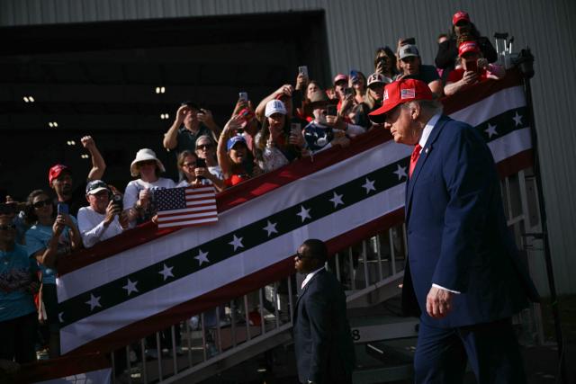 US President Donald Trump arrives to speak at a midterm campaign rally at Dalton Municipal Airport in Dalton, Georgia, on October 16, 2026. Trump is campaigning for US Representative Mike Collins for US Senate and Rick Jackson for governor. (Photo by Brendan SMIALOWSKI / AFP)