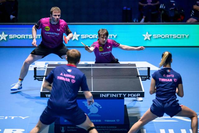 Germany’s Nina Mittelham (up R) and Benedikt Duda (up L) compete during the Mixed Doubles match of the 2026 ETTU European Individual Table Tennis Championships at the Arena Stozice in Ljubljana, Slovenia on October 16, 2026. (Photo by Jure Makovec / AFP)