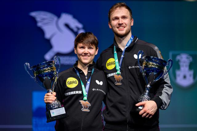 Germany’s Nina Mittelham (R) and Benedikt Duda pose for photos after winning the Mixed Doubles final match of the 2026 ETTU European Individual Table Tennis Championships at the Arena Stozice in Ljubljana, Slovenia on October 16, 2026. (Photo by Jure Makovec / AFP)