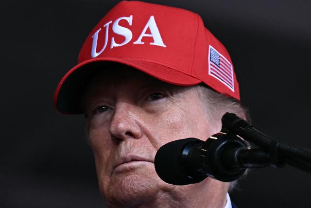 US President Donald Trump speaks at a midterm campaign rally at Dalton Municipal Airport in Dalton, Georgia, on October 16, 2026. Trump is campaigning for US Representative Mike Collins for US Senate and Rick Jackson for governor. (Photo by Brendan SMIALOWSKI / AFP)