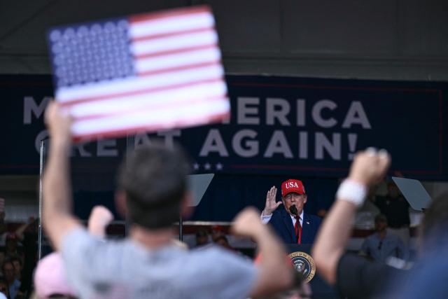 US President Donald Trump speaks at a midterm campaign rally at Dalton Municipal Airport in Dalton, Georgia, on October 16, 2026. Trump is campaigning for US Representative Mike Collins for US Senate and Rick Jackson for governor. (Photo by Brendan SMIALOWSKI / AFP)
