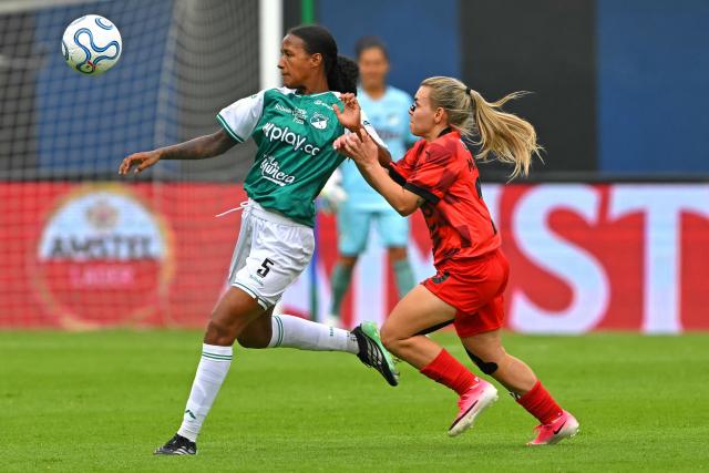 Deportivo Cali's defender #05 Stefania Perlaza and Libertad's midfielder #10 Ramona Martinez fight for the ball during the 2026 Women's Copa Libertadores Group D football match between Colombia's Deportivo Cali and Paraguay's Libertad at the Rodrigo Paz Delgado Stadium in Quito on October 16, 2026. (Photo by Rodrigo BUENDIA / AFP)