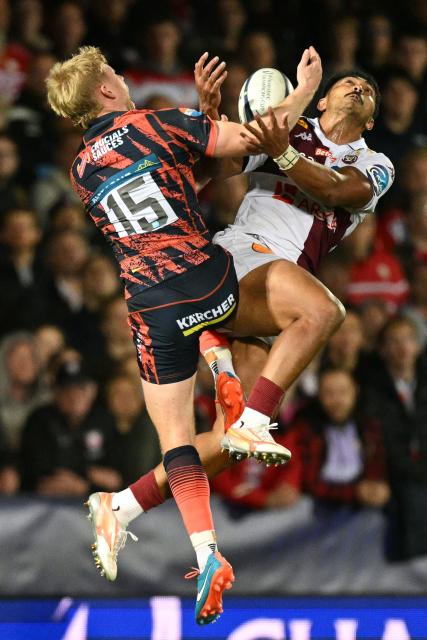 Gloucester's English full-back George Barton (L) and Bordeaux-Begles' French centre Yoram Moefana (R) compete for a high ball during the European Champions Cup pool 3 rugby union match between Gloucester and Bordeaux-Begles at the Kingsholm Stadium in Gloucester, western England on October 16, 2026. (Photo by Oli SCARFF / AFP)