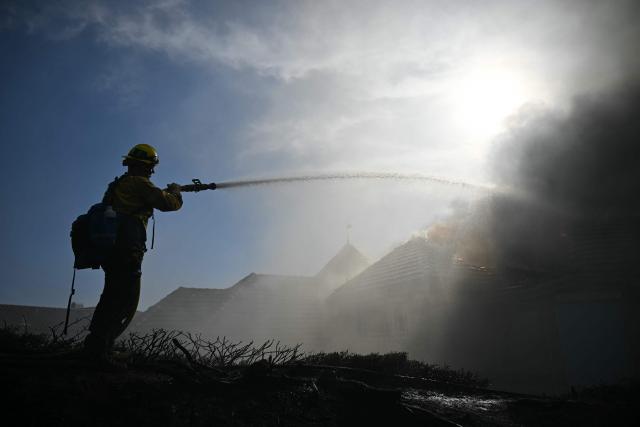 Firefighter battles the Norte Fire in San Juan Capistrano, California, on October 16, 2026. Evacuation orders have been issued for parts of Orange County. (Photo by Patrick T. Fallon / AFP)