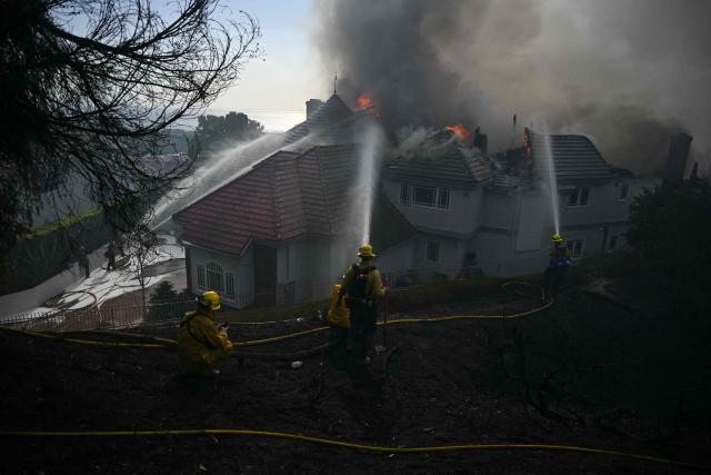 Firefighters battle the Norte Fire in San Juan Capistrano, California, on October 16, 2026. Evacuation orders have been issued for parts of Orange County. (Photo by Patrick T. Fallon / AFP)