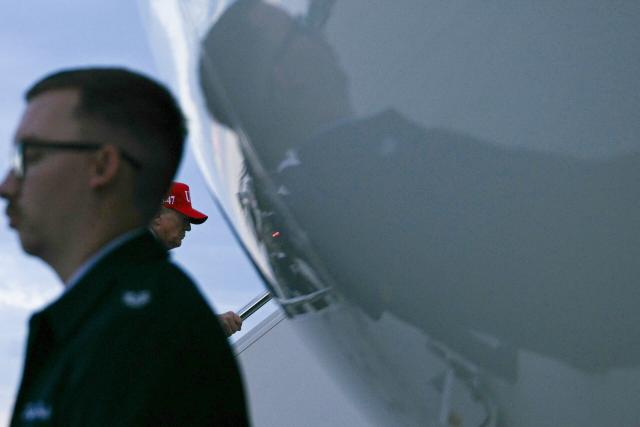US President Donald Trump boards Air Force One at Dobbins Reserve Air Base in Marietta, Georgia, on October 16, 2026. Trump was campaigning for US Representative Mike Collins for US Senate and Rick Jackson for governor. (Photo by Brendan SMIALOWSKI / AFP)
