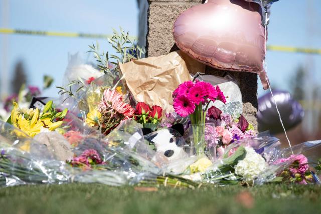 Flowers, toys, and other items are left at a vigil outside of Silver Rail Elementary School in Bend, Oregon, on October 16, 2026. Three children and one teacher were shot dead at an elementary school on October 15 in the northwestern US state of Oregon, police said, adding that the assailant was a 16-year-old who was killed by an armed bystander. (Photo by Payton Bruni / AFP)