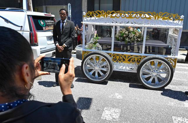 Fans of the singer Mighty Sparrow father during a funeral procession in Port of Spain on October 16, 2026. A huge caravan brought hundreds of Trinidadians together on Friday to bid farewell with music and merrymaking to Mighty Sparrow, the legendary singer-songwriter who died in September and who brought calypso from the Caribbean island to the rest of the world. (Photo by Robert Taylor / AFP)