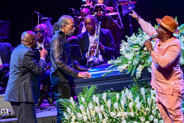Artists and fans of singer Mighty Sparrow perform during funeral at an amphitheater in Port of Spain on October 16, 2026. A huge caravan brought hundreds of Trinidadians together on Friday to bid farewell with music and merrymaking to Mighty Sparrow, the legendary singer-songwriter who died in September and who brought calypso from the Caribbean island to the rest of the world. (Photo by Robert TAYLOR / AFP)