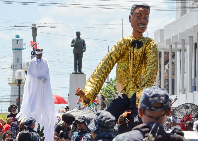Fans of the singer Mighty Sparrow father during a funeral procession in Port of Spain on October 16, 2026. A huge caravan brought hundreds of Trinidadians together on Friday to bid farewell with music and merrymaking to Mighty Sparrow, the legendary singer-songwriter who died in September and who brought calypso from the Caribbean island to the rest of the world. (Photo by Robert Taylor / AFP)