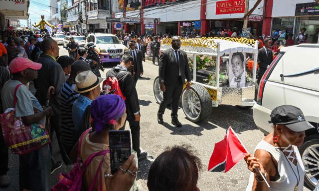 Fans of the singer Mighty Sparrow father during a funeral procession in Port of Spain on October 16, 2026. A huge caravan brought hundreds of Trinidadians together on Friday to bid farewell with music and merrymaking to Mighty Sparrow, the legendary singer-songwriter who died in September and who brought calypso from the Caribbean island to the rest of the world. (Photo by Robert Taylor / AFP)