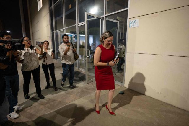 State assigned prosecutor Anahi Nunez leaves the civil court facilities after the sentencing hearing of three murderers of Australian brothers Callum and Jake Robinson and US citizen Jack Carter Rhoad during a surfing trip in April 2024, in Ensenada, Baja California state, Mexico on October 16, 2026. A Mexican court on October 16, 2026, sentenced each of the three murderers to 158 years in prison. (Photo by Guillermo Arias / AFP)