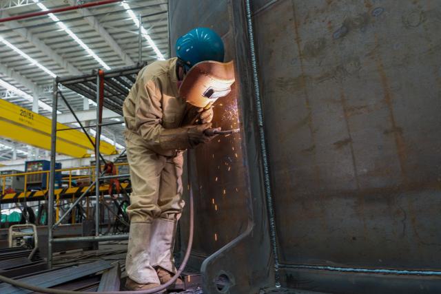 A worker welds at the production workshop of Nantong Hongbo Technology in Nantong, in eastern China's Jiangsu province, on October 15, 2026. (Photo by CN-STR / AFP) / China OUT
