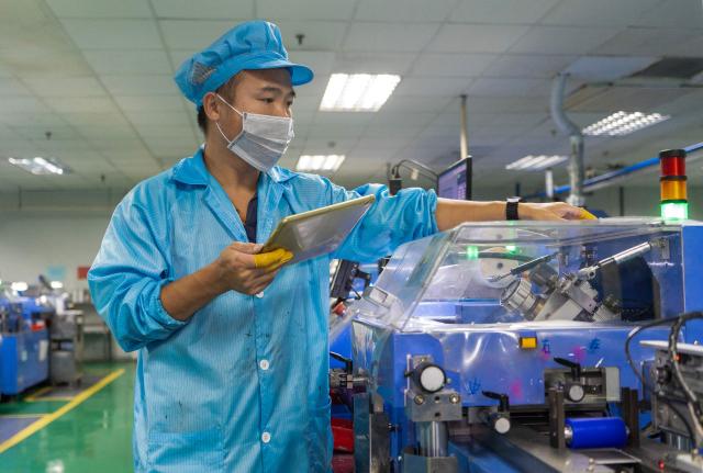 A worker produces surface-mount resistors at Lizhi Electronics, a Taiwan-invested company in Nantong, in eastern China's Jiangsu province, on October 15, 2026. (Photo by CN-STR / AFP) / China OUT