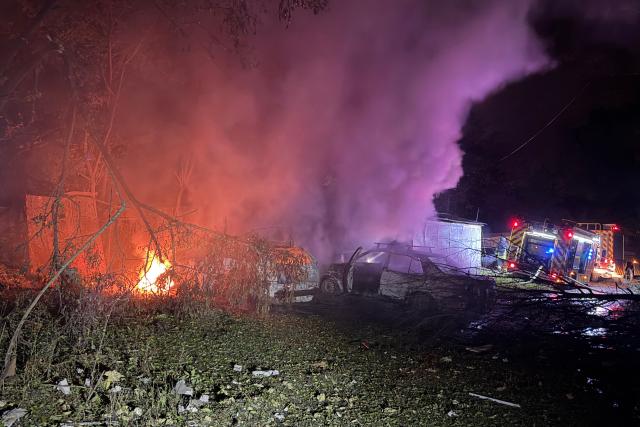 Rescuers put out a fire outside a residential buildings damaged following a Russian missile attack in Zaporizhzhia, on October 17, 2026, amid the Russian invasion of Ukraine. (Photo by Daria Nazarova / AFP)