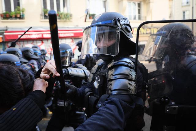 Police officers clash with protester during a demonstration to protest against the "high cost of living", in Paris on October 17, 2026 as part of a nationwide call for mobilisation bringing together various groups expressing their anger: former "Yellow Vests", secondary school and university students, climate activists and even farmers. After weeks of student protests, France faces broader, nationwide demonstrations on October 17, 2026 over the cost of living, setting up a potentially fraught six months heading into a presidential election. A police source told AFP that authorities estimated nearly 200,000 people could take part, with 40,000 in Paris. (Photo by Kiran RIDLEY / AFP)