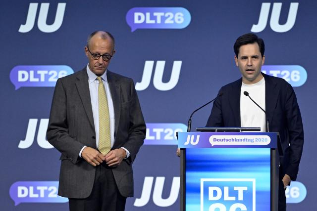 German Chancellor Friedrich Merz (L) listens to Johannes Winkel, Chairman of the Junge Union (JU), which is the youth organization of Germany's conservative Christian Democratic Union (CDU) party, at the JU's Deutschlandtag congress in Bonn, western Germany on October 17, 2026. (Photo by INA FASSBENDER / AFP)