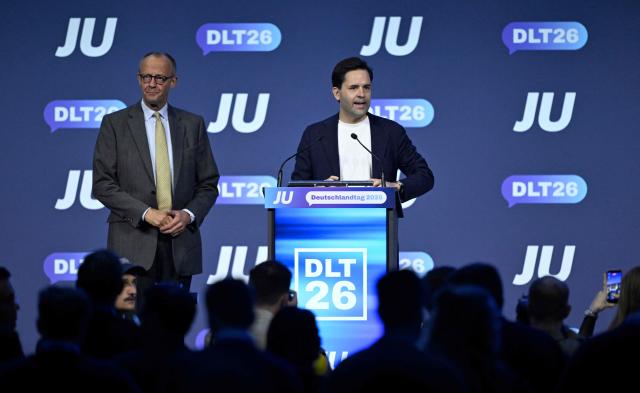 German Chancellor Friedrich Merz (L) listens to Johannes Winkel, Chairman of the Junge Union (JU), which is the youth organization of Germany's conservative Christian Democratic Union (CDU) party, at the JU's Deutschlandtag congress in Bonn, western Germany on October 17, 2026. (Photo by INA FASSBENDER / AFP)