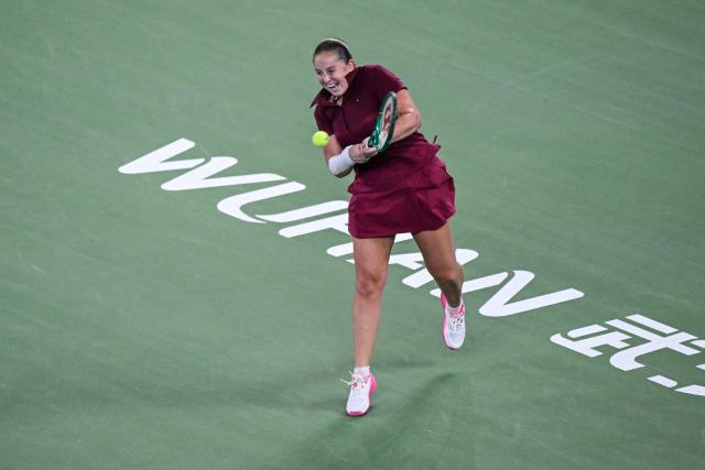 Latvia's Jelena Ostapenko hits a return to Sonay Kartal during their women's singles semi-final match at the Wuhan Open tennis tournament in Wuhan, China's Hubei province on October 17, 2026. (Photo by WANG Zhao / AFP)