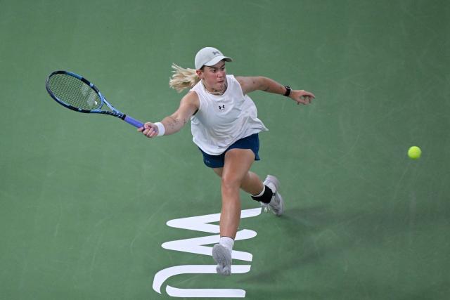 Britain's Sonay Kartal hits a return to Latvia's Jelena Ostapenko during their women's singles semi-final match at the Wuhan Open tennis tournament in Wuhan, China's Hubei province on October 17, 2026. (Photo by WANG Zhao / AFP)