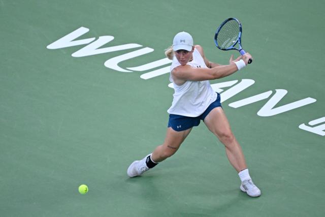 Britain's Sonay Kartal hits a return to Latvia's Jelena Ostapenko during their women's singles semi-final match at the Wuhan Open tennis tournament in Wuhan, China's Hubei province on October 17, 2026. (Photo by WANG Zhao / AFP)