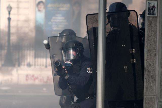 A French national police officer fires tear gas during clashes prior to the start of a demonstration to protest against the "high cost of living", in Marseille, southern France, on October 17, 2026 as part of a nationwide call for mobilisation bringing together various groups expressing their anger: former "Yellow Vests", secondary school and university students, climate activists and even farmers. After weeks of student protests, France faces broader, nationwide demonstrations on October 17, 2026 over the cost of living, setting up a potentially fraught six months heading into a presidential election. A police source told AFP that authorities estimated nearly 200,000 people could take part, with 40,000 in Paris. (Photo by Thibaud MORITZ / AFP)