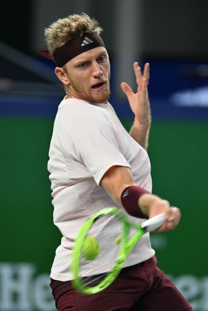 Spain's Alejandro Davidovich Fokina hits a return to Germany's Alexander Zverev during their men's singles semi-final match at the Shanghai Masters tennis tournament in Shanghai on October 17, 2026. (Photo by Hector RETAMAL / AFP)