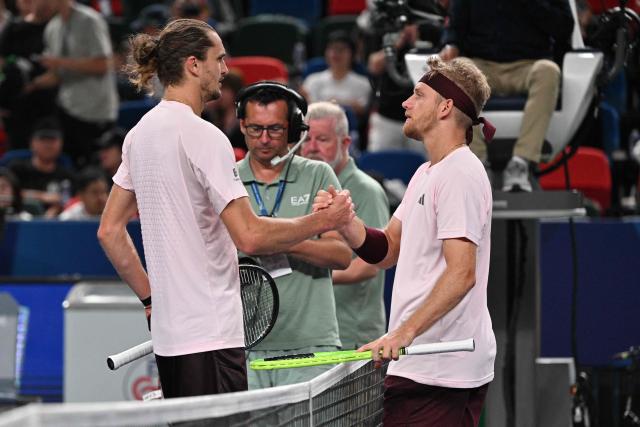 Spain's Alejandro Davidovich Fokina (R) shakes hands with Germany's Alexander Zverev after their men's singles semi-final match at the Shanghai Masters tennis tournament in Shanghai on October 17, 2026. (Photo by Hector RETAMAL / AFP)