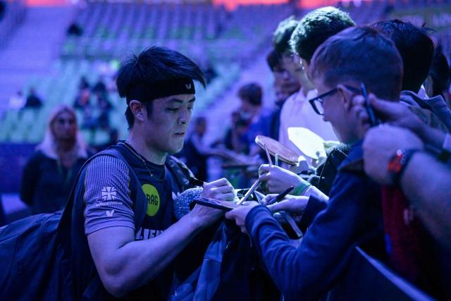Germany’s Dang Qiu signs autographs after winning against France’s Alexis Lebrun the men’s singles quarter-final match of the 2026 ETTU European Individual Table Tennis Championships at The Arena Stozice in Ljubljana on October 17, 2026. (Photo by Jure Makovec / AFP)