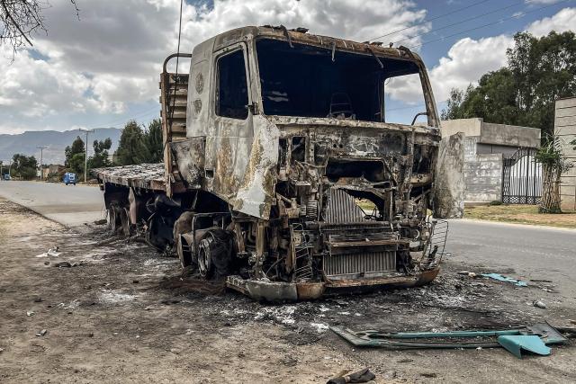 A truck belonging to the Tigray People's Liberation Front (TPLF) stands burned along a road following clashes between Ethiopian federal forces and armed groups opposed to the government in Adigrat on October 17, 2026. Ethiopian Prime Minister Abiy Ahmed announced the establishment of an interim administration in the northern Tigray region, which has been controlled by rebels who have clashed with federal forces in recent weeks.
The Tigray People's Liberation Front (TPLF) launched a major offensive against government forces on September 23, before being pushed back and losing control of its strongholds, including the regional capital Mekelle.
In late September, the TPLF formed an uneasy alliance with several disparate armed groups opposed to the government. The group has also moved closer to neighbouring Eritrea, long at odds with Ethiopia. (Photo by AFP)
